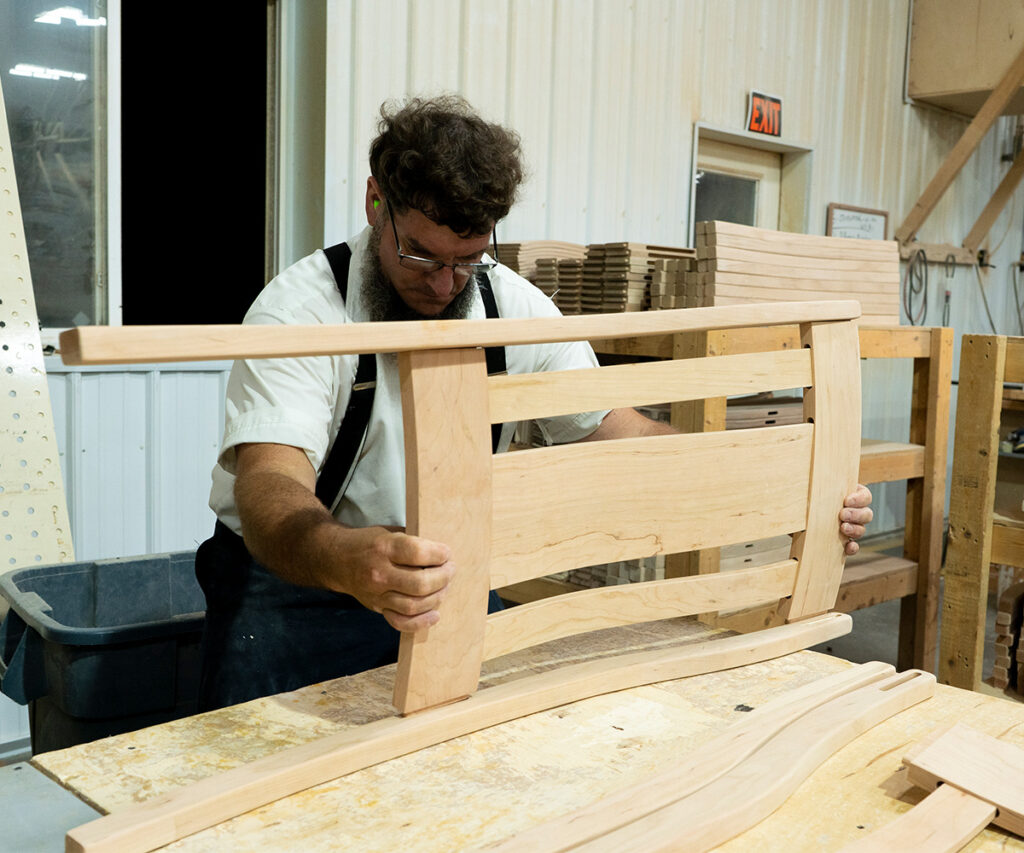 Amish craftsmen putting together a chair